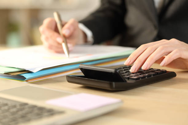 istock Bookkeepper hands calculating with calculator 1218587054