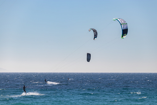 Tarifa, Spain. 3rd February, 2020. Many kitesurfers doing sports in the Atlantic ocean near the windy Bolonia beach