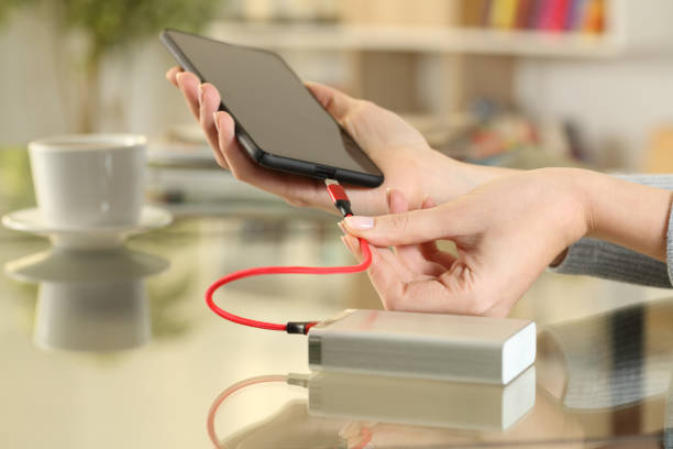 istock Woman hands plugging power bank on phone 1218587738