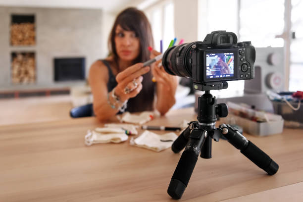 istock Woman doing a video blogging to teach how to make creative cute protective masks 1218588194