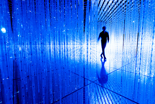 Man walking in the blue lights.