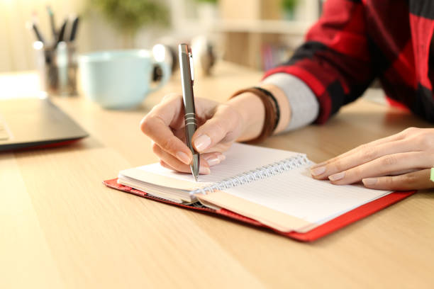 istock Student girl hands writing reminder on agenda 1218588563