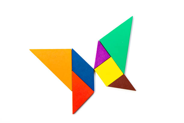istock Color wood tangram puzzle in butterfly shape on white background 1218589399