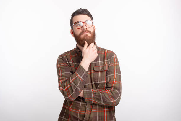 istock handsome man with beard wearing glasses and thinking of something 1218589812