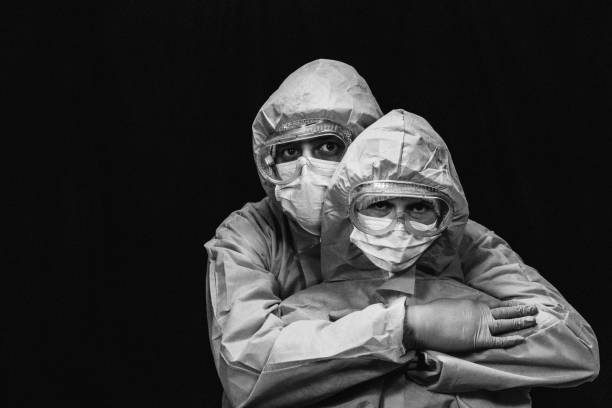 istock Virus. Man and woman in protective antivirus suit hugging. 1218590117