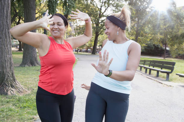 istock Two women exercising outside in the park 1218590308