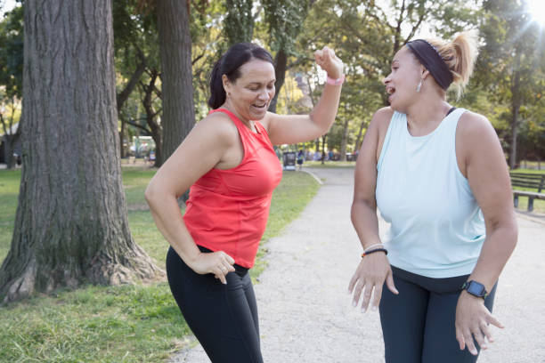 istock Two women exercising outside in the park 1218590317