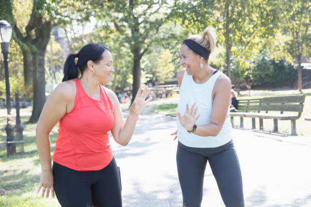 istock Two women exercising outside in the park 1218590338