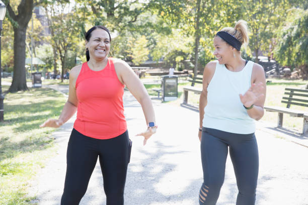 istock Two women exercising outside in the park 1218590344