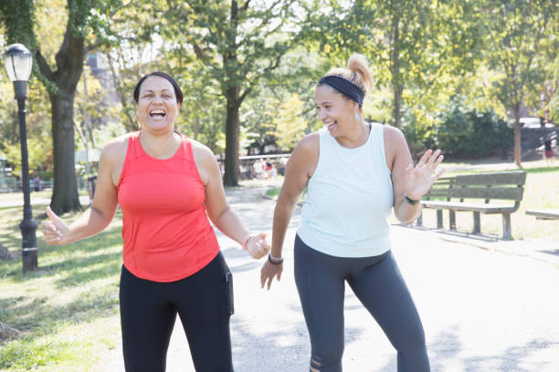 istock Two women exercising outside in the park 1218590347