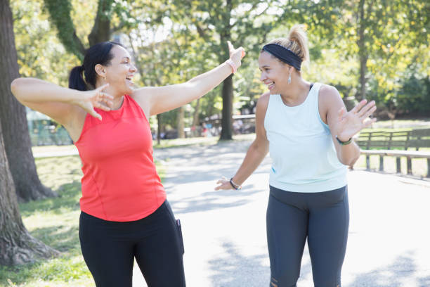 istock Two women exercising outside in the park 1218590367