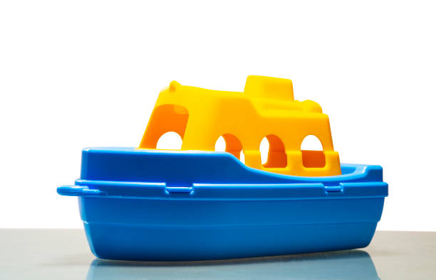 lonely little toy ship lonely little toy ship with white background isolated toy boat stock pictures, royalty-free photos & images