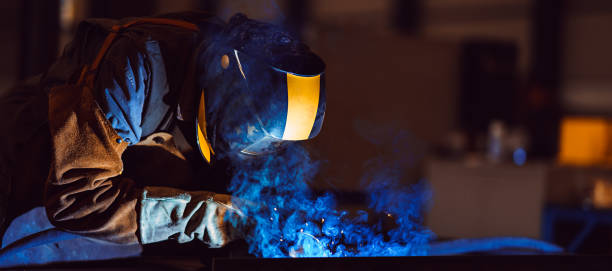 istock Industrial Welder With Torch and Protective Helmet 1218591916