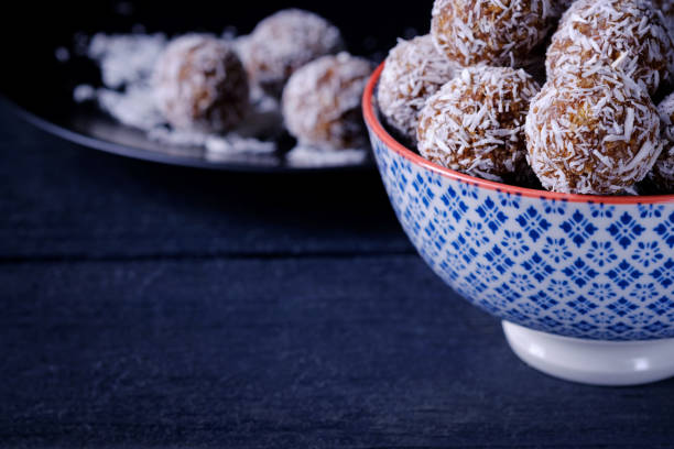istock Coconut chocolate energy balls  closeup on dark background with copy space 1218592154