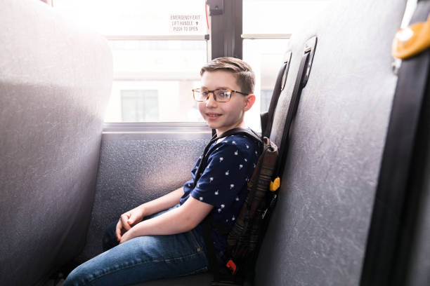 istock Young boy, waiting patiently on school bus, smiles for camera 1218592621