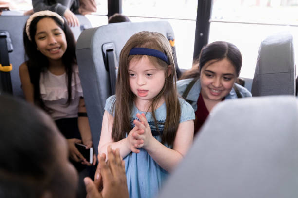 istock Older student teaches kindergarten girl a clapping game 1218592737