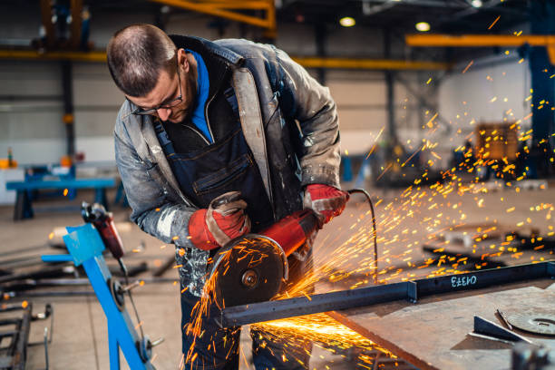 istock Factory worker cutting metal with grinder. 1218593549