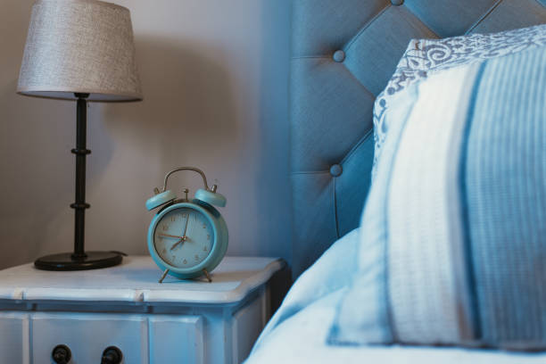 istock Alarm clock next to bed daily routine sleep time wake up 1218594344