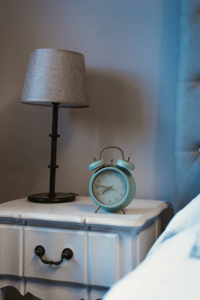 istock Alarm clock next to bed daily routine sleep time wake up 1218594345