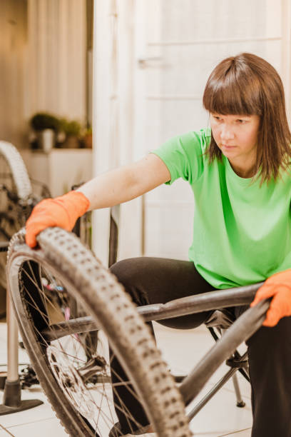istock woman repairing a flat tire 1218595367