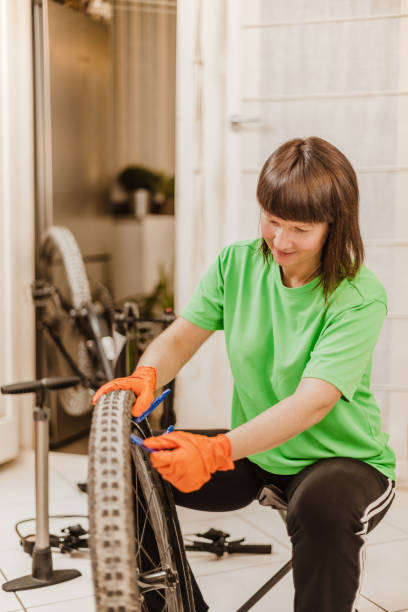 istock woman repairing a flat tire 1218595493