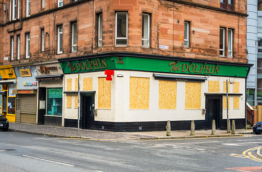 Glasgow, Scotland - The Dolphin Bar in Partick, closed and boarded up during the Covid-19 pandemic.