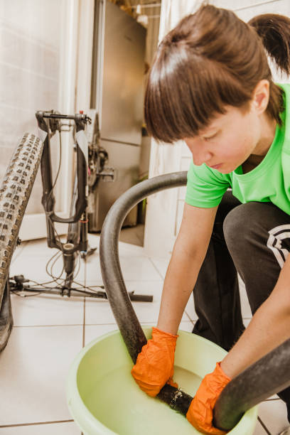 istock woman repairing a flat tire 1218595727