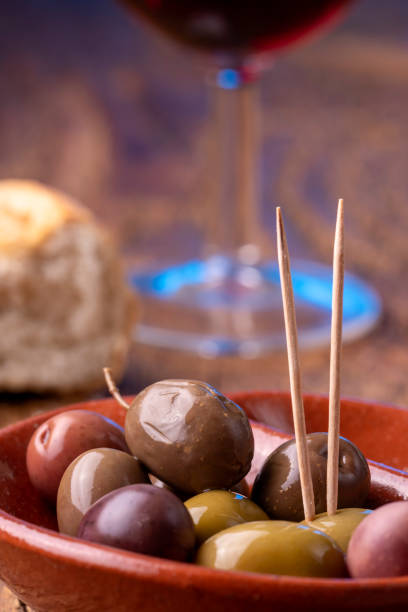 istock mixed olives on dark wood 1218598716