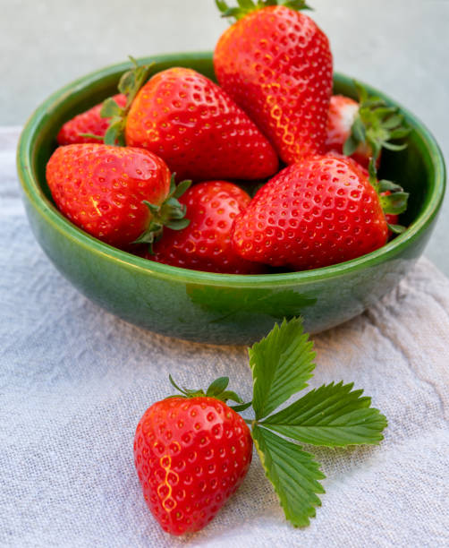 istock Red ripe strawberries in green bowl 1218599777