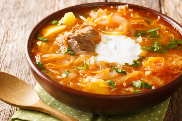 istock Russian sour cabbage soupe shchi with beef on a wooden background. horizontal 1218599900
