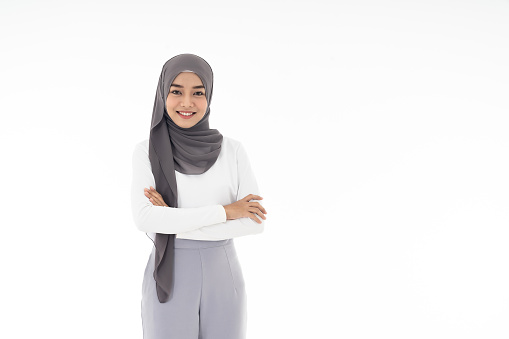 Portrait of young adult asian Muslim confident woman on white background. Positive face expression, studio shot.