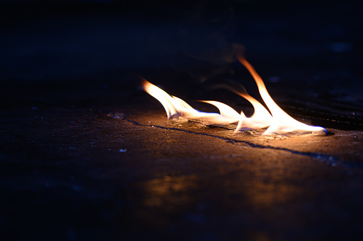 Flame on floor with dark background