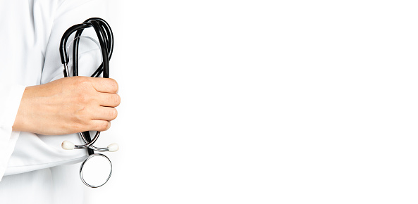 Doctor holding stethoscope at the white background.