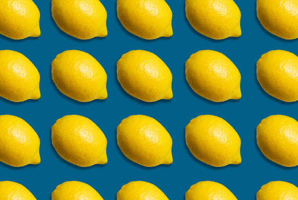 istock Many fresh lemons on a bright blue background lay. An idea creative for producing work within marketing communications. 1218601614
