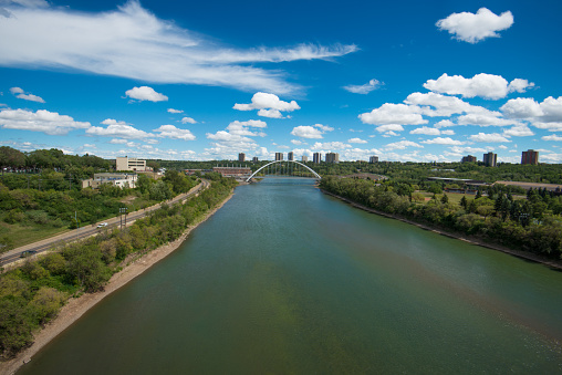 View of North Saskatchewan River and the Walterdale Bridge on sunny day from the vantage point of Edmonton Alberta's Low Level Bridge.  Wide Angle lens.