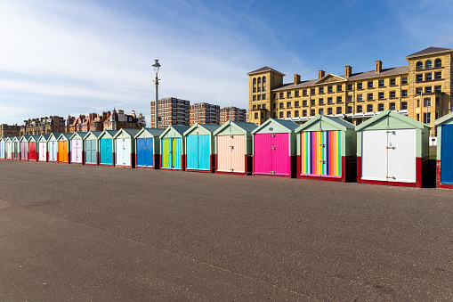 Colourful beach huts on the sea front, Brighton, Sussex, UK