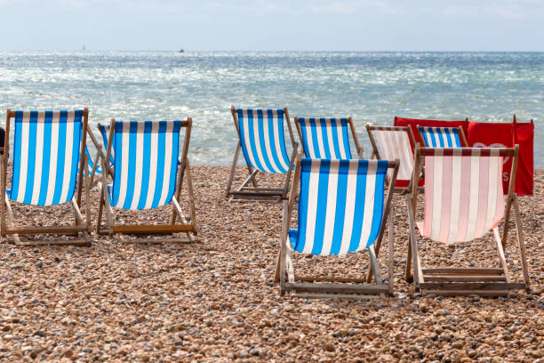 istock Colourful striped deck chairs on Brighton beach, England 1218603265