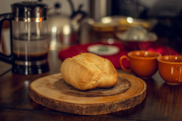 istock Breakfast wood table with hot bread and coffee from a French Press. 1218603844