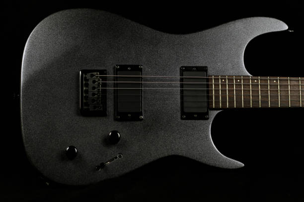 istock Grey electric guitar on a black background 1218604634