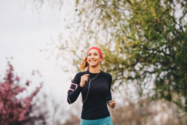 Athletic woman running in nature and dawn.
