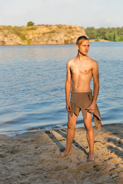 istock guy in loincloth on the background of river beach 1218609577