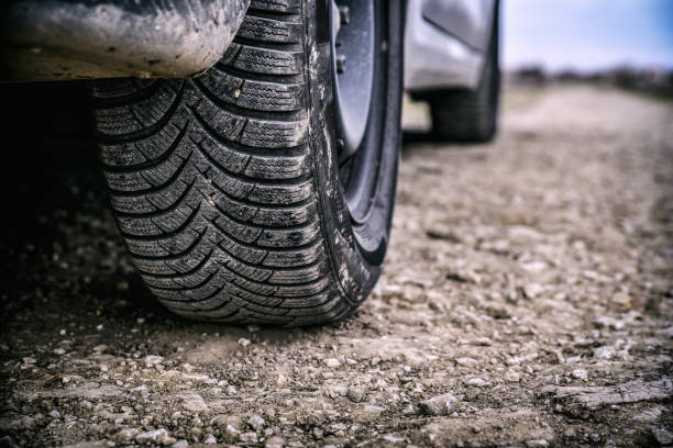 istock car wheel on country road 1218609653