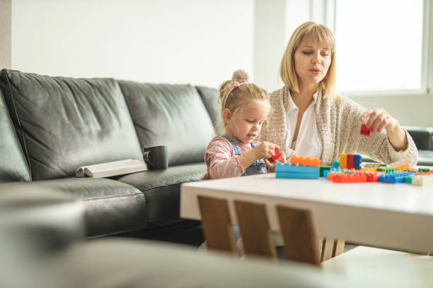 istock Mother and daughter playing with toy bricks 1218609952