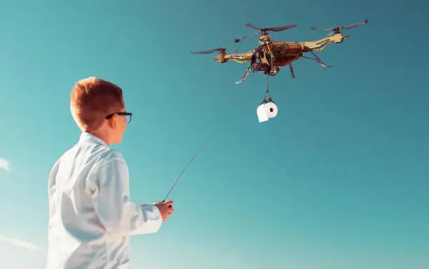 Photo of Drone pilot controls drone flying in the air holding roll of toilet paper