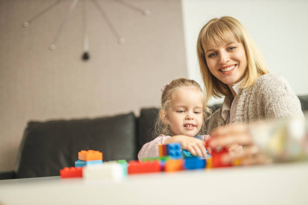 istock Mother and daughter playing with toy bricks 1218611208