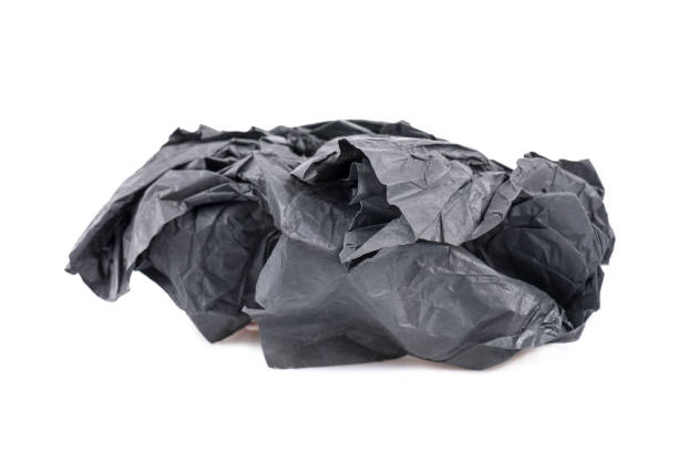 istock Crumpled black paper on a white background 1218611596