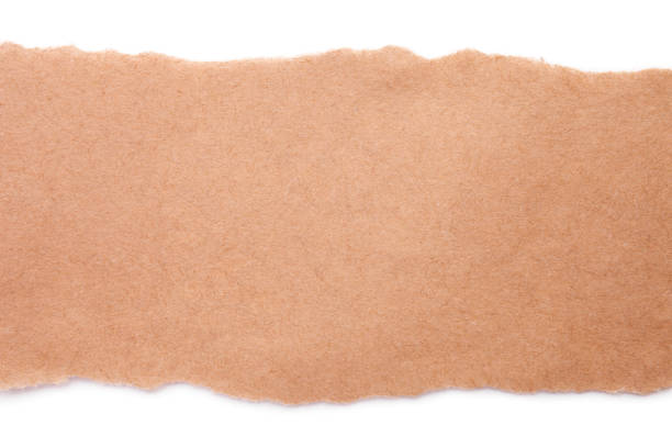 istock Torn craft paper isolated on white background. Brown paper texture with place for text, top view 1218612171