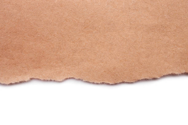 istock Torn craft paper isolated on white background. Brown paper texture with place for text, top view 1218612212