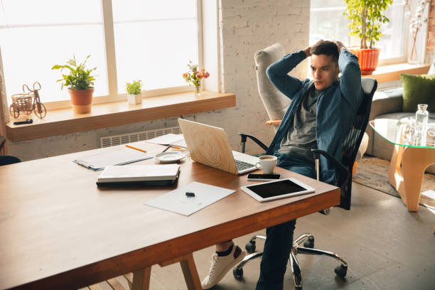 istock Creative workplace - organized work space as you like for inspiration, man working in office in relaxed posture 1218612327