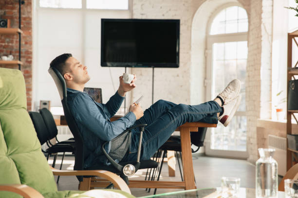 istock Creative workplace - organized work space as you like for inspiration, man working in office in relaxed posture 1218612357